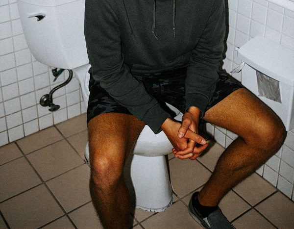 man sitting on the toilet